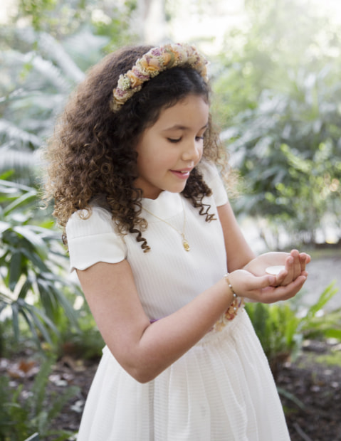 Girl taking the Eucharist for her First Communion