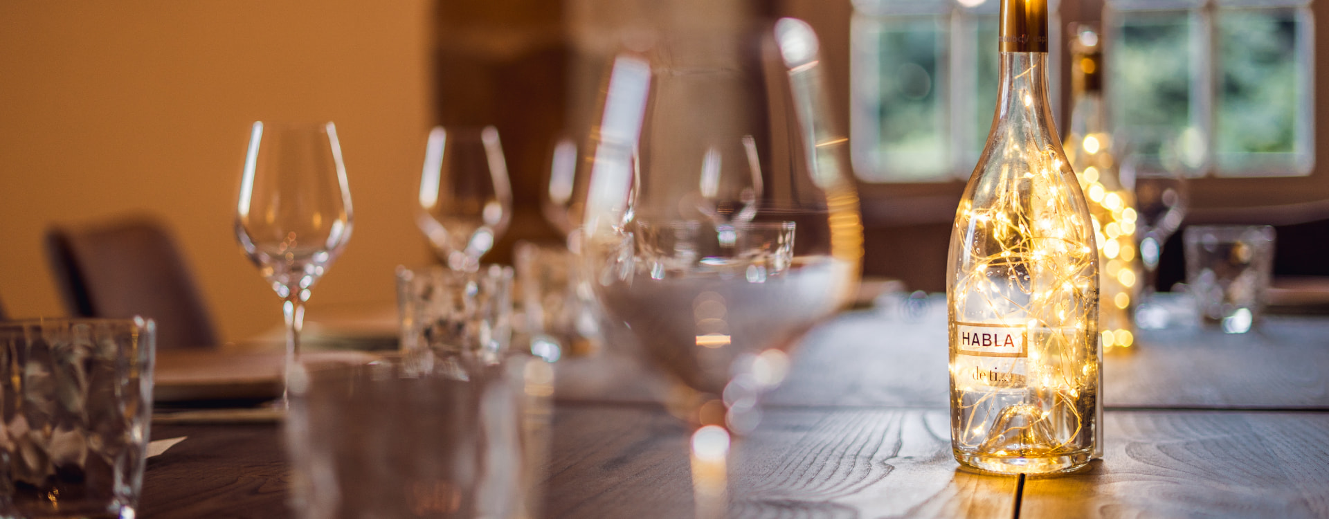 Table decorated with glass bottles and lights