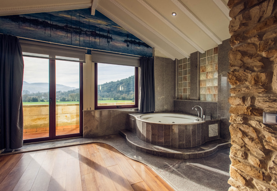 Bath with hydromassage bathtub with outdoor views