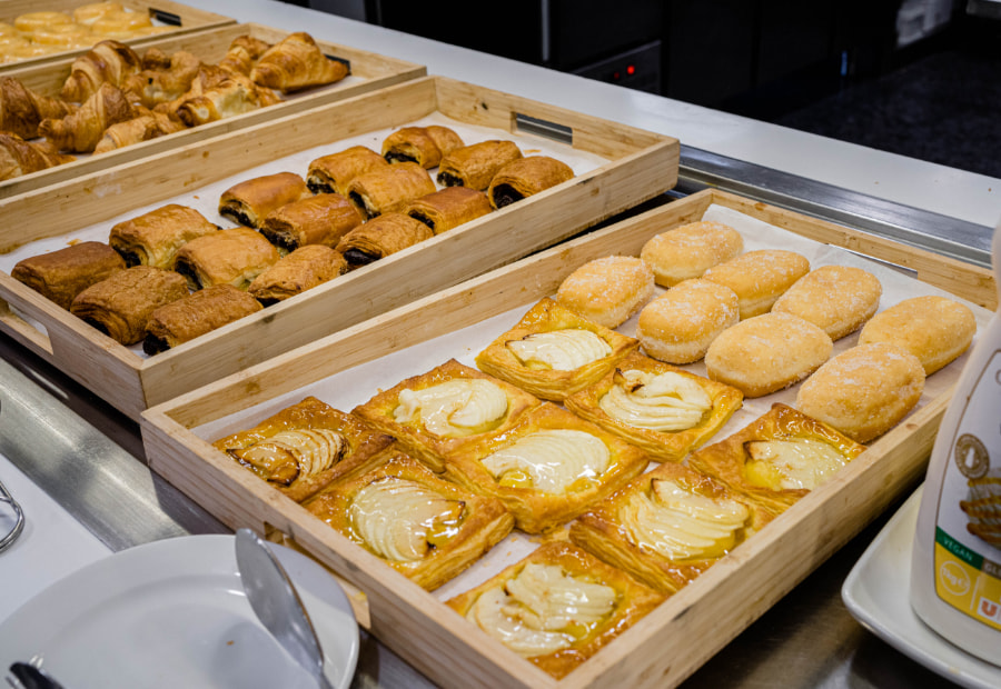 Person holding a plate of food at an open buffet